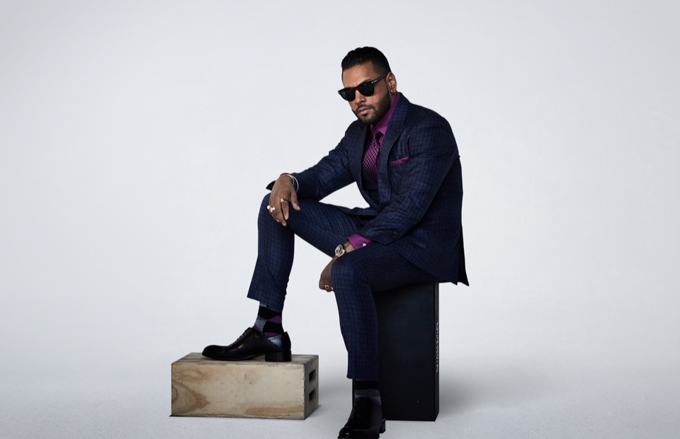 Studio portrait of Jas Mathur in a tailored navy suit